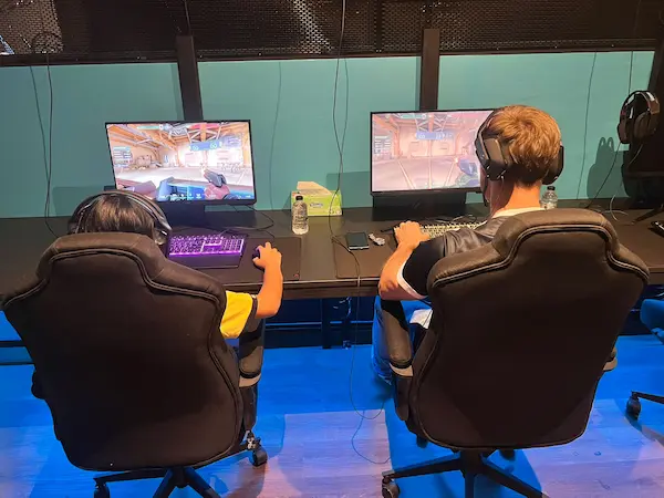 Gaming pod setup with professional chairs and equipment